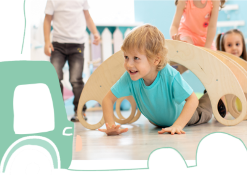 A young child in an aqua top crawls under a wooden climbing arch while friends play at Fun Street soft play